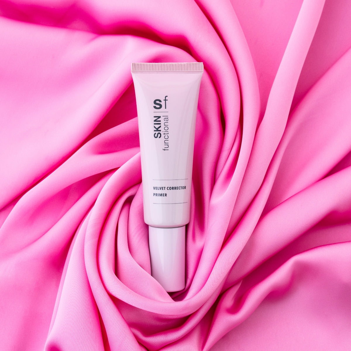 Skin Functional tube labeled 'Skin Functional' on a pink fabric background